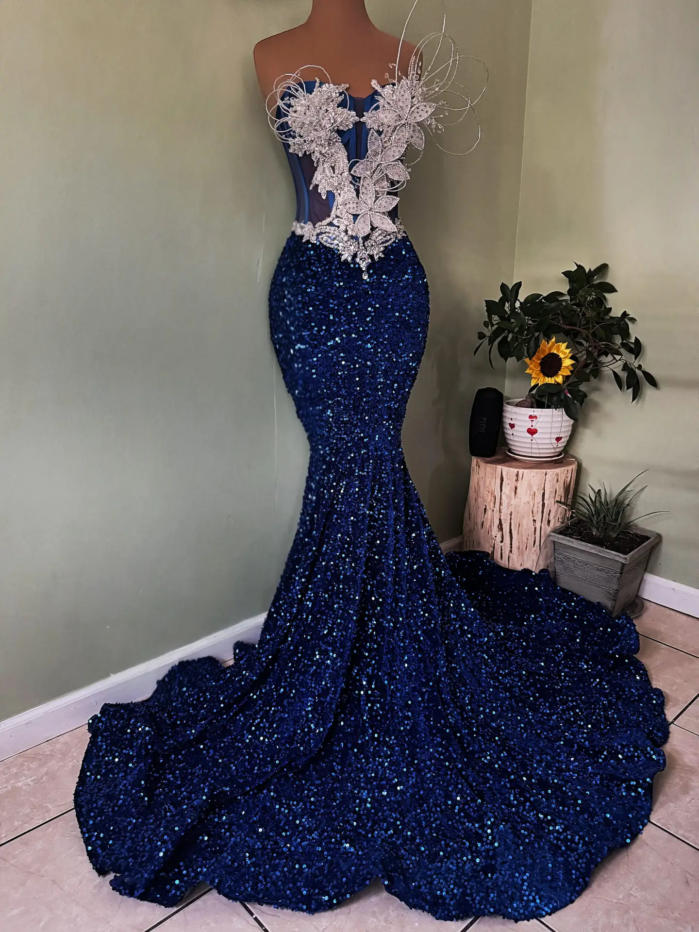 This blue and silver evening gown is more than just a dress—it is a statement of confidence. The cool-toned palette is universally flattering, making it a top choice for those seeking a winter formal dress or a standout pageant gown. Pair it with silver stiletto heels and teardrop earrings to lean into the icy aesthetic, or go bold with a dark navy clutch for a monochromatic look.