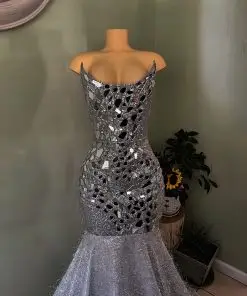 Silver mirror embellishment detailing Structured corset bodice Figure-enhancing mermaid silhouette Dramatic flared hem and train Glamorous reflective finish